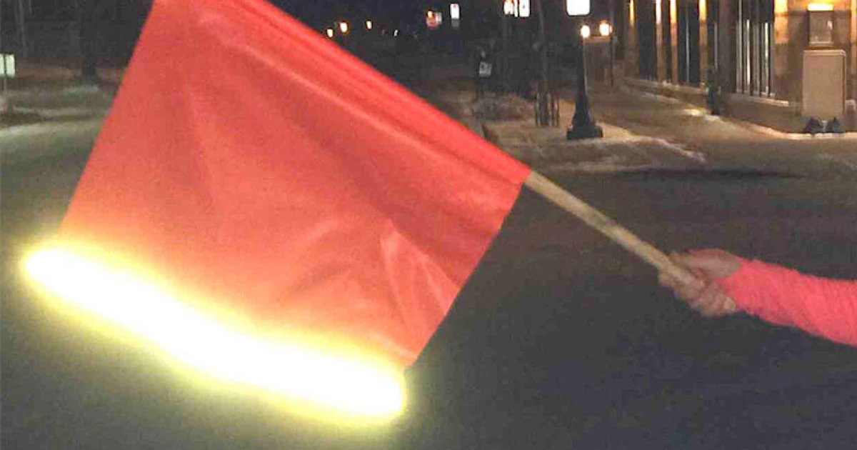 Woman holding flag with reflective stripe